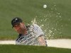 Former champion Jose Maria Olazabal of Spain hits from a sand trap on the 18th green during first round play in the 2013 Masters golf tournament in Augusta