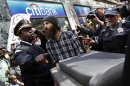 Chicago Police prevent protesters from placing furniture on the sidewalk in front of a bank during one of the demonstrations during the week ahead of the NATO meeting in Chicago