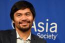 Boxer Manny Pacquiao speaks to reporters after touring the Asia Society in New York on October 12, 2015