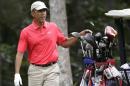 President Barack Obama selects a club while golfing at Farm Neck Golf Club, in Oak Bluffs, Mass., on the island of Martha's Vineyard, Saturday, Aug. 23, 2014. Obama is vacationing on the island. (AP Photo/Steven Senne)
