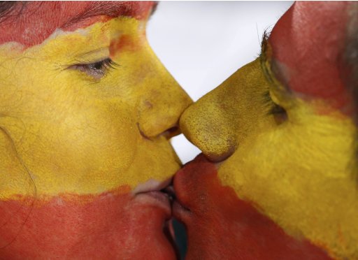 Spain soccer fans kiss as they wait for the start of the Euro 2012 semi-final soccer match between Portugal and Spainat the Donbass Arena in Donetsk