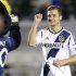 Los Angeles Galaxy midfielder Rogers fist pumps the team's mascot Cozmo after playing in the MLS soccer game against the Seattle Sounders in Carson