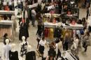 Shoppers look over merchandise at Hennes & Mauritz, H&M store in Peru, at the Jockey Plaza mall in Lima