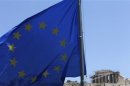A E.U. flag flutters in front of the monument of Parthenon on Acropolis hill in Athens