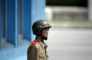 A North Korean soldier keeps watch on the south at the truce village of Panmunjom