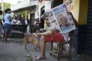 A man reads a newspaper fronted with the news of the death of Nobel laureate Gabriel Garcia Marquez, in Aracataca, the town were he was born in Colombia's Caribbean coast, Friday, April 18, 2014. Garcia Marquez died in Mexico City on Thursday April 17. (AP Photo/Ricardo Mazalan)