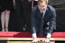 Director Nolan puts his handprints in cement during a hand and footprint ceremony in the Grauman's Chinese Theatre in Hollywood