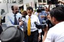 Former U.S. congressman from New York and current Democratic candidate for New York City Mayor Anthony Weiner is followed the media as he leaves his New York City apartment