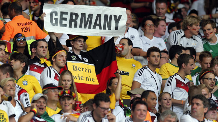 Germany fans wait for the beginning of the World Cup semifinal soccer match between Brazil and Germany at the Mineirao Stadium in Belo Horizonte, Brazil, Tuesday, July 8, 2014. Poster reads &#39;German, ready as never&#39;. (AP Photo/Frank Augstein)