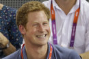 FILE- Britain's Prince Harry watches track cycling during the 2012 Summer Olympics, in this file photo dated Thursday, Aug. 2, 2012, in London. Nude photographs of Prince Harry in a Las Vegas, USA, hotel room are published on the Internet Wednesday Aug. 22, 2012, and now security experts are wondering whether the Scotland Yard officers who are assigned to keep the 27-year-old royal safe from harm, might have done a better job of keeping him out of trouble. The photos available on the Internet and not taken by Photographers' long lenses but are up close and personal. (AP Photo/Matt Rourke, File)