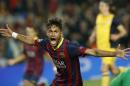 Barcelona's Neymar celebrates after scoring his sides first goal during a first leg quarterfinal Champions League soccer match between Barcelona and Atletico Madrid at the Camp Nou stadium in Barcelona, Spain, Tuesday April 1, 2014. (AP Photo/Emilio Morenatti)