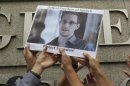 Protesters supporting Edward Snowden, a contractor at the National Security Agency (NSA), hold a photo of Snowden during a demonstration outside the U.S. Consulate in Hong Kong June 13, 2013