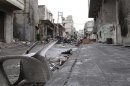 A damaged plastic chair is seen among rubble on a damaged street in Aleppo's al-Amereya district