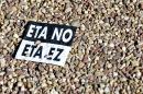 A sticker reading in Spanish (Top) and Basque "No to ETA" lies on the ground as thousands of Spaniards gather to protest in Madrid on October 27, 2013