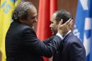 Prince Ali bin al-Hussein, right, with UEFA President Michel Platini, left, after announcing his withdrawal during the 65th FIFA Congress at the Hallenstadion in Zurich, Switzerland, Friday, May 29, 2015. Sepp Blatter has been re-elected as FIFA president for a fifth term, chosen to lead world soccer despite separate U.S. and Swiss criminal investigations into corruption. The 209 FIFA member federations gave the 79-year-old Blatter another four-year term on Friday after Prince Ali bin al-Hussein of Jordan conceded defeat after losing 133-73 in the first round. (Walter Bieri/Keystone via AP)