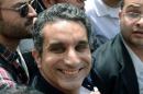Egyptian satirist and television host Bassem Youssef is surrounded by his supporters upon his arrival at the public prosecutor's office in the high court in Cairo, on March 31, 2013