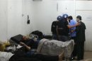 U.N. chemical weapons experts visit a hospital where wounded people affected by an apparent gas attack are being treated, in the southwestern Damascus suburb of Mouadamiya