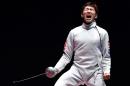 South Korea's Park Sangyoung celebrates winning against Hungary's Geza Imre in the men's individual epee gold medal bout as part of the fencing event of the Rio 2016 Olympic Games, on August 9, 2016, at the Carioca Arena 3
