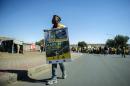 South African ruling party African National Congress supporters hold signs as they take part in a march against South African power supplier ESKOM and to protest against power cuts on May 14, 2015 in township of Soweto, Johannesburg