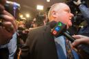 Toronto Mayor Rob Ford is surrounded by the media as he waits for an elevator outside his office at Toronto City Hall on November 15, 2013