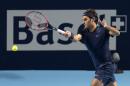 Switzerland's Roger Federer returns a ball to Germany's Philipp Kohlschreiber during their match at the Swiss Indoors tennis tournament at the St. Jakobshalle in Basel, Switzerland, on Thursday, Oct. 29, 2015. (Georgios Kefalas/Keystone via AP)