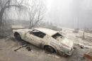 A car destroyed by the Butte Fire sits on tireless rims at a home in Mountain Ranch, Calif., Saturday, Sept. 12, 2015. Firefighters gained some ground Saturday against the explosive wildfire that incinerated buildings and chased hundreds of people from mountain communities in drought-stricken Northern California. (AP Photo/Rich Pedroncelli)