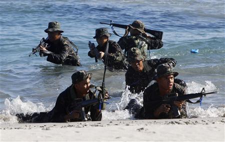 Philippine Military Academy (PMA) cadets take up positions for assault on a beach during a joint field training exercise at the Marines' training centre in Ternate, Cavite city, south of Manila May 29, 2013. REUTERS/Romeo Ranoco
