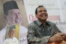 Founder and chairman CT Corp Tanjung smiles as his sits in front of his portrait at a book shop during his book launch in Jakarta