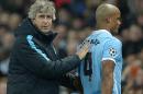 Manchester City's manager Manuel Pellegrini (L) consoles defender Vincent Kompany as he leaves the pitch injured during the UEFA Champions League match agaisnt Dynamo Kiev on March 15, 2016