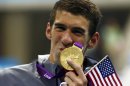 Michael Phelps of the U.S. kisses his 19th Olympic medal presented to him in the men's 4x200m freestyle relay victory ceremony during the London 2012 Olympic Games at the Aquatics Centre