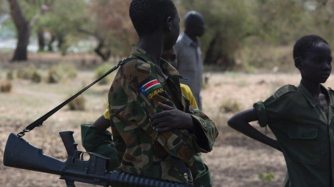Young boys, children soldiers attend a ceremony marking the disarmament of child soldiers, their demobilisation and reintegration in Pibor, South Sudan on February 10, 2015
