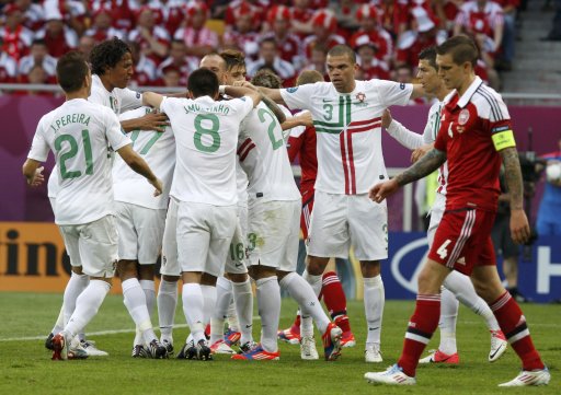Portugal's Pepe celebrates with team mates after scoring a goal during their Group B Euro 2012 soccer match against Denmark at the New Lviv stadium in Lviv