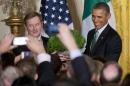 Irish Prime Minister Enda Kenny, left, and President Barack Obama, hold up a bowl of Irish shamrocks during a St. Patrick's Day reception in the East Room of the White House in Washington, Friday, March 14, 2014. (AP Photo/Manuel Balce Ceneta)