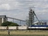 A man walks past a train carrying goods, at Anglo Platinum's Khomanani shaft 1 mine in Rustenburg