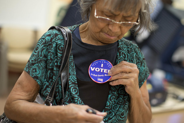 Aida Castillo places a sticker on her blouse indicating that she had voted during the early voting period, Saturday, Oct. 20, 2012, in Las Vegas. In the heavily-Hispanic neighborhoods of Las Vegas, unemployment is high and home values are down. But President Barack Obama's immigration stand has locked in support from a fast-growing demographic group that has been trending sharply Democratic in the wake of increasingly hard-line Republican positions on immigration. Part of the reason is his executive order that allows people brought into the country illegally as children to avoid deportation if they graduate high school or join the military. The president's campaign is counting on Hispanics providing the margin of victory not just in Nevada, but in other swing states such as Colorado, Iowa, Virginia and North Carolina. (AP Photo/Julie Jacobson)