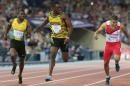 Kemar Bailey-Cole of Jamaica centre, wins the men's 100 meter race as he looks across at Adam Gemili, right, of England who came second at Hampden Park Stadium during the Commonwealth Games 2014 in Glasgow, Scotland, Monday July 28, 2014. (AP Photo/ Scott Heppell)