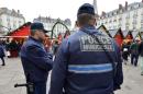 Municipal police patrol the Christmas market in the French city of Nantes on December 23, 2014, a day after a man rammed into shoppers with his car
