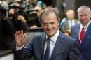 European Council President Donald Tusk waves as he arrives for an EU summit in Brussels on Thursday, Dec. 18, 2014. European Union leaders met Thursday to seek solutions to two major challenges, how to jumpstart sluggish economic growth at home, and how to deal long-term with Russia. (AP Photo/Virginia Mayo)