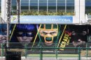 A bus with advertisement for movie "Kick-Ass 2" drives past the San Diego Convention Center