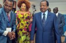 Cameroonian outgoing President Paul Biya (R) and his wife Chantal arrive at a polling station