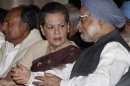 Indian Prime Minister Manmohan Singh, right, talks to Congress party president Sonia Gandhi as Defense Minister A.K. Antony, left, looks away during the swearing-in ceremony for the new ministers in New Delhi, India, Sunday, Oct. 28, 2012. India's Prime Minister Manmohan Singh reshuffled his Cabinet on Sunday in a bid to overhaul his government's image ahead of state and national elections over the next 18 months. (AP Photo)