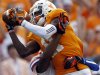 Tennessee wide receiver Justin Hunter (11) catches a pass as Florida defensive back Loucheiz Purifoy (15) defends during the first quarter of an NCAA college football game on Saturday, Sept. 15, 2012, in Knoxville, Tenn. (AP Photo/Wade Payne)