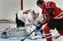Canada's forward Corey Perry (R) attacks Hungary's goalie Zoltan Hetenyi during the group B preliminary round game of the 2016 IIHF Ice Hockey World Championship on May 8, 2016