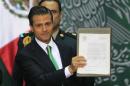 Mexico's President Enrique Pena Nieto signed into law a radical reform of the country's energy, at the National Palace in Mexico City