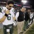New York Jets quarterback Mark Sanchez (6) and head coach Rex Ryan bow their heads during a moment of silence for the victims of the Sandy Hook Elementary School shootings in Newtown, Conn., before an NFL football game against the Tennessee Titans, Monday, Dec. 17, 2012, in Nashville, Tenn. (AP Photo/Wade Payne)