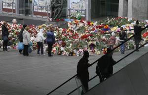 People stand near to floral tributes for the victims&nbsp;&hellip;