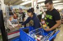 Erica Avegalio, center, and her brother Albert Avegalio, right, load up on water and food at the Times Supermarket after learning of a tsunami warning Saturday, Oct. 27, 2012, in Honolulu. A tsunami warning has been issued for Hawaii after a 7.7-magnitude earthquake rocked an island off the west coast of Canada. The Pacific Tsunami Warning Center originally said there was no threat to the islands, but a warning was issued later Saturday and remains in effect until 7 p.m. Sunday. A small craft advisory is in effect until Sunday morning. (AP Photo/Eugene Tanner)