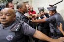 Supporters of former Brazilian president Luiz Inacio Lula da Silva confront police officers during a protest in front of Lula's apartment in Sao Bernardo do Campo