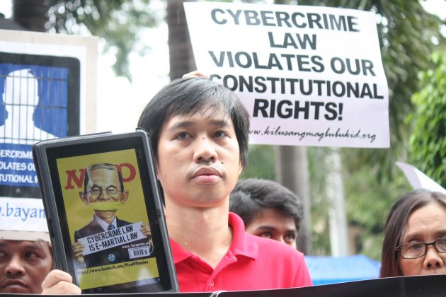 A protester displays a placard and wears a tape over his mouth during a rally against the new Anti-Cybercrime Law by the Aquino government, at the Supreme Court in Manila, on 02 October 2012. The Supreme Court is set to tackle during its en banc session today several petitions questioning the constitutionality of certain provisions of Republic Act (RA) 10175, or the Cybercrime Prevention Act of 2012. Protesters called the law as a threat to Filipinos' right to freedom of expression. (Jhun Dantes Jr/NPPA Images)