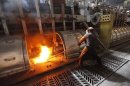 A worker operates an electrolysis furnace, which produces aluminium from raw materials, at the Rusal Krasnoyarsk aluminium smelter in the Siberian city of Krasnoyarsk